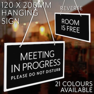 May include: Black and white hanging sign, 120 x 200mm, with the text "MEETING IN PROGRESS PLEASE DO NOT DISTURB" on one side and "ROOM IS FREE" on the reverse. The sign is available in 21 colours.