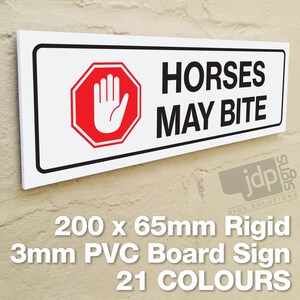 May include: White rectangular sign with black border and red stop sign with a white hand print. The sign reads "Horses May Bite". The sign is 200mm x 65mm and made of 3mm rigid PVC board.  The sign is available in 21 colours.