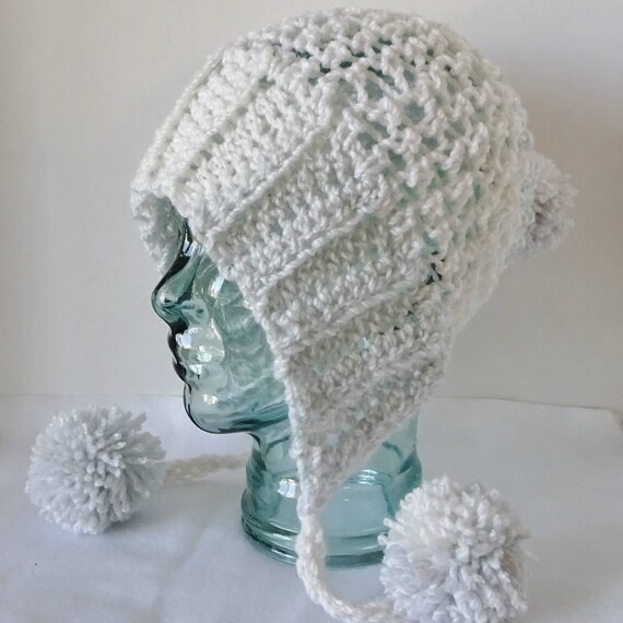white knit hat with ear flaps
