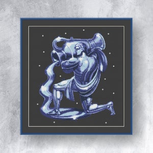 May include: A cross-stitch design depicting the Aquarius zodiac sign. The image shows a blue-toned illustration of a figure pouring water from a large vessel, set against a dark background with white star accents, framed in a blue border.