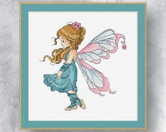 May include: Cross-stitch art of a fairy in a teal dress with pink and white wings. The fairy has long, flowing blonde hair and a pink flower in her hair. The artwork is framed in a gold-colored frame with a teal mat.