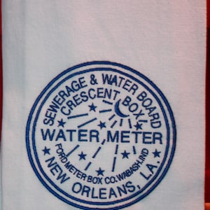 Embroidered, Vintage tea towel with New Orleans water meter cover.