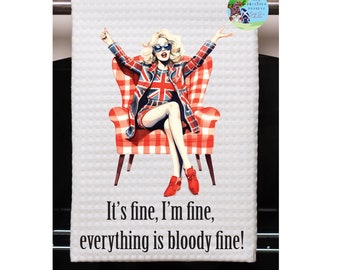 May include: A white kitchen towel with a red and white checkered chair and a woman wearing a red, white, and blue jacket and skirt sitting in the chair. The text on the towel reads "It's fine, I'm fine, everything is bloody fine!"