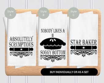 May include: Three kitchen towels with different pie-themed designs. The first towel says "Absolutely Scrumptious" with a rolling pin and star. The second towel says "Nobody Likes a Soggy Bottom" with a pie and a decorative border. The third towel says "Star Baker" with a rolling pin and star.