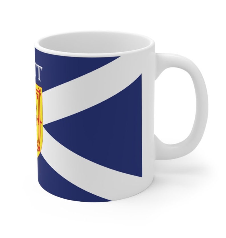 May include: White ceramic mug with a blue and white Scottish flag design. The flag features a white diagonal cross on a blue background with a yellow and red crest in the upper left corner. The text "SCOTT" is printed on the mug.