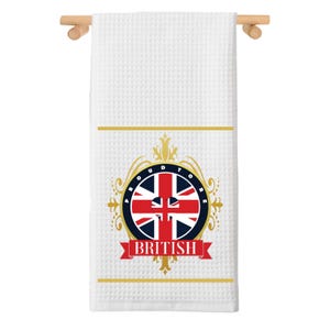 May include: White kitchen towel with a gold and red design featuring the Union Jack flag and the text "Proud to be British".
