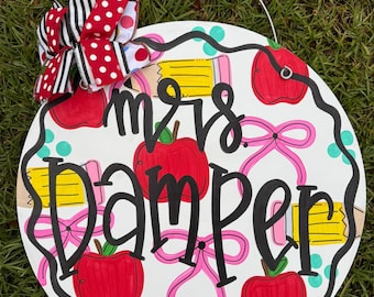 Teacher themed apple pencil bow pink colorful cursive print back to school door hanger