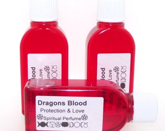 May include: Three small red glass bottles with white caps filled with a red liquid. The bottles have white labels with black text that reads "Dragons Blood Protection & Love Spiritual Perfume".