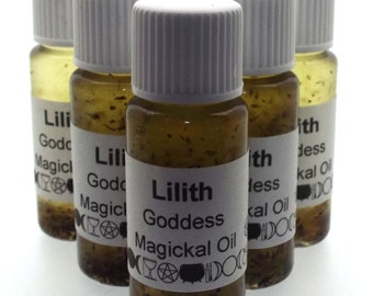 May include: A collection of small glass bottles filled with a golden-brown liquid. Each bottle has a white label with the text "Lilith Goddess Magickal Oil" in black. The bottles are capped with white lids.