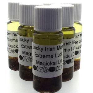 May include: Six small glass bottles with white lids filled with a green liquid. The labels on the bottles read "Lucky Irish Moss Extreme Luck Magickal Oil".