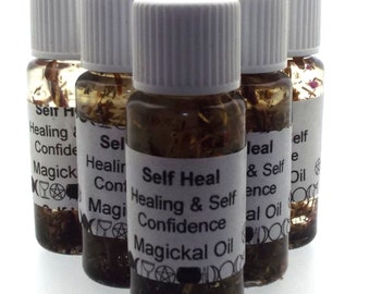 May include: Six small glass bottles with white lids filled with a brown liquid and herbs. The bottles have white labels with the text "Self Heal Healing & Self Confidence Magickal Oil".