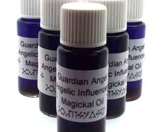 May include: Five small glass bottles with white caps and labels. The labels are white with black text and symbols. The bottles are filled with a dark blue liquid. The text on the labels reads "Guardian Angel Angelic Influence Magickal Oil".
