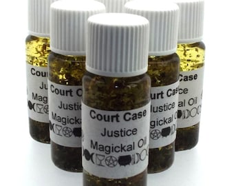 May include: Six small glass bottles with white lids filled with a green liquid and gold glitter. Each bottle has a white label with black text that reads "Court Case Justice Magickal Oil".