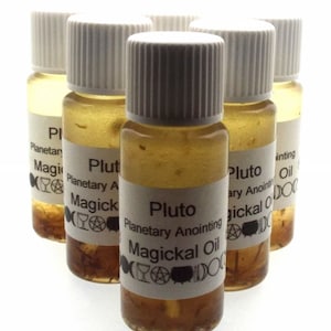 May include: Six small glass bottles with white lids filled with a light brown liquid. Each bottle has a white label with black text that reads "Pluto Planetary Anointing Magickal Oil". The labels also feature a variety of symbols.