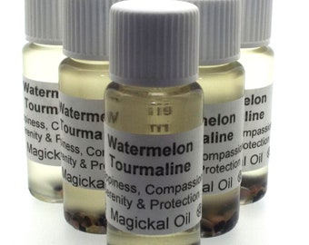 May include: Five small glass bottles with white caps filled with a clear liquid and small crystals. The bottles are labeled with the text "Watermelon Tourmaline Magickal Oil" and describe the oil's properties: happiness, compassion, serenity, and protection.