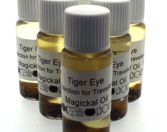 May include: Six small glass bottles with white caps and labels. The labels read "Tiger Eye Protection for Travellers Magickal Oil". The bottles contain a golden liquid and dark brown sediment.
