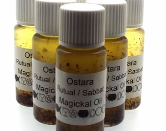 May include: Six small glass bottles with white lids filled with a yellow liquid and herbs. Each bottle has a white label with the text "Ostara Ritual / Sabbat Magickal Oil".