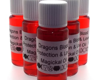 May include: Five small glass bottles with white caps filled with a red liquid. Each bottle has a white label with black text that reads "Dragons Blood Protection & Love Magickal Oil" and various symbols.