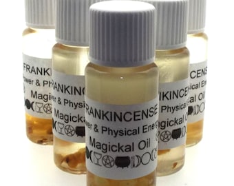 May include: A collection of small glass bottles filled with a light amber liquid. Each bottle has a white label with black text that reads "FRANKINCENSE Magickal Oil". The bottles have white caps and contain small, dark particles.