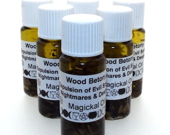 May include: Six small glass bottles with white caps filled with a brown liquid and herbs. Each bottle has a white label with black text that reads "Wood Betony Expulsion of Evil Spirits Nightmares & Despair Magickal Oil".