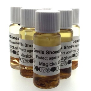 May include: Six small glass bottles with white lids filled with a clear liquid and herbs. The bottles have labels that say "Devils Shoestrings Protect against Magical Oil".