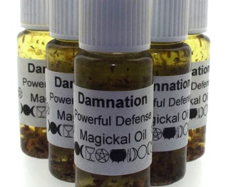 May include: Five small glass bottles with white lids and labels. The labels are white with black text and symbols. The bottles contain a clear liquid with herbs and glitter. The labels read "Damnation Powerful Defense Magickal Oil".