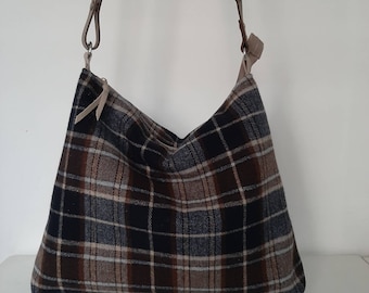 Shoulder bag or hobo bag made of classic tartan fabric. Fashionable and trendy crossbody bag adjustable leather strap, winter wardrobe