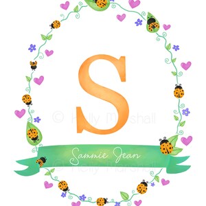 May include: A green leafy wreath with orange and black ladybirds, pink hearts, and purple flowers surrounds a large orange letter S. A green ribbon with the text "Sammie Jean" is at the bottom of the wreath.