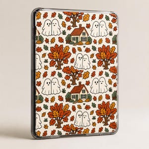 May include: A clear tablet case featuring a repeating pattern of smiling ghosts, small houses with chimneys, and autumn trees with orange, yellow, and green leaves on a cream background. The design covers the entire back of the rectangular device.