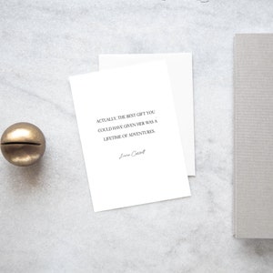 May include: A white card with a quote about the best gift being a lifetime of adventures. The quote is attributed to "La Cartell".