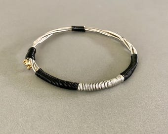 Recycled Electric Guitar String Bracelet, styled with silver and black copper wire. Unisex Unique Guitarist Gift