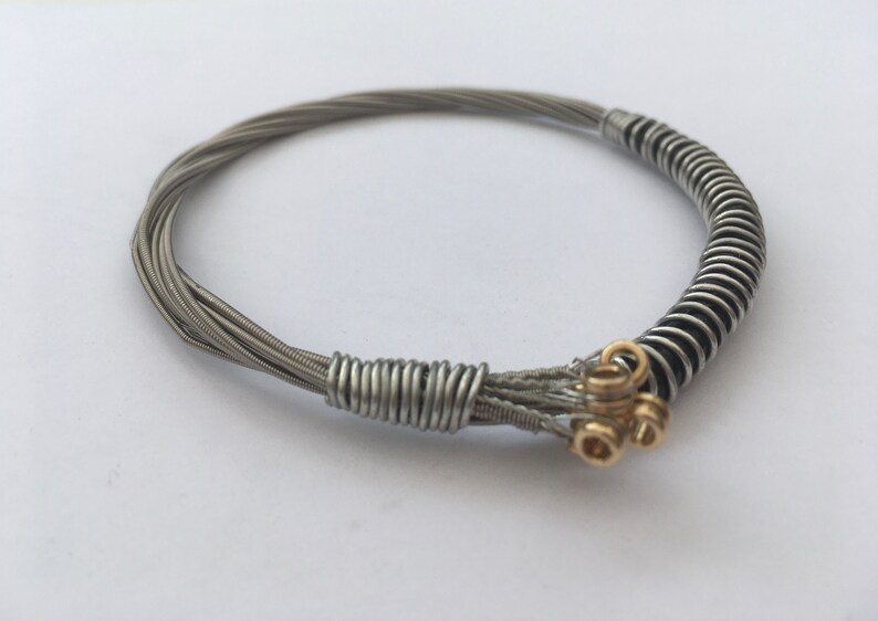 Recycled Guitar String Bracelet, styled with silver plated copper wire. Unisex Unique Guitarist Gift Six Strings