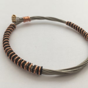 Recycled Guitar String Bracelet, styled with black and bronze copper wire. Unisex Unique Guitarist Gift