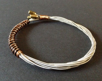 Recycled Guitar String Bracelet styled With Fender Bullet End Strings and wrapped with black and bronze wire. Unisex Unique Guitarist Gift