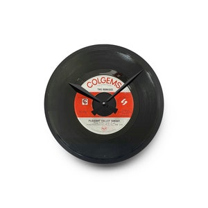 May include: Black vinyl record clock featuring a red and white label with the text "Colgems" and "The Monkees" and the song title "Pleasant Valley Sunday".