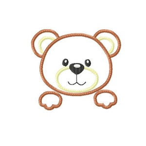 May include: A brown teddy bear face with a yellow outline. The bear has black eyes, a black nose, and a yellow mouth.
