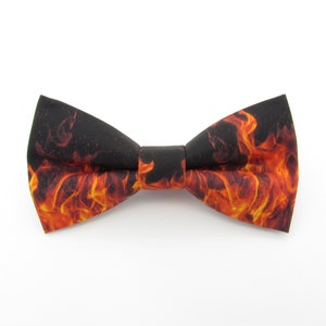 May include: A black bow tie with a flame pattern in shades of orange and yellow.