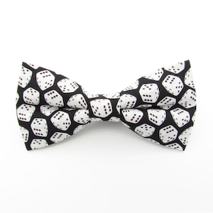 May include: A black bow tie with a white dice pattern.