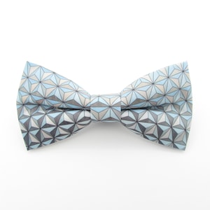 May include: A blue and gray bow tie with a geometric pattern.
