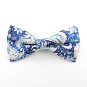May include: A blue bow tie with a white paisley pattern.