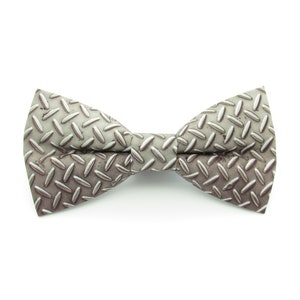 May include: A gray bow tie with a diamond pattern, resembling a metal tread plate.