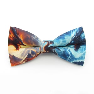 May include: A blue and orange bow tie with a dragon design. The bow tie features a dragon on each side, one with blue flames and the other with orange flames.
