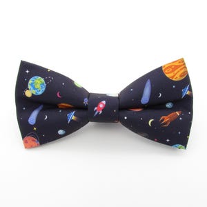 Ribbon: Space Rockets - Antique White 16mm (per metre) Ribbon: Space Rockets - Antique White 16mm (per metre)