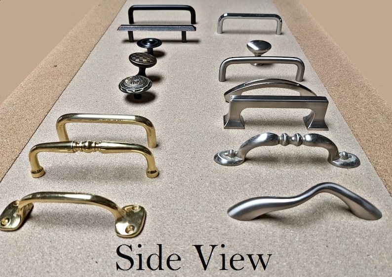 May include: A collection of cabinet hardware, including handles and knobs, in various styles and finishes. The hardware includes black, silver, and gold tones. The image is labeled "Side View".