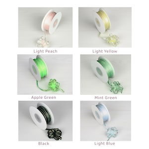 May include: Spools of decorative ribbon in various colors, including light peach, light yellow, apple green, mint green, black, and light blue. Each spool has a matching decorative bow. The text labels each color.