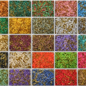 May include: A collection of 25 different coloured shredded paper with gold glitter. The paper is arranged in a grid pattern.