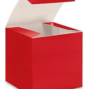 May include: A red cardboard box with a hinged lid, perfect for packaging small gifts or favors.