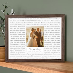 May include: A framed print with a wedding photo of a bride and her father, set within song lyrics. The frame is dark brown. The text at the bottom reads "I love you, Daddy! Forever your little girl, Clara."