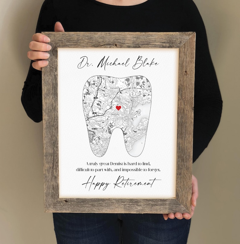 May include: Framed print with a map design in the shape of a tooth, featuring a red heart and the text "Dr. Michael Blake" and "Happy Retirement." The frame is made of rustic wood.