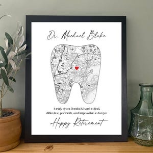 May include: Black framed print with a map of an area shaped like a tooth, with a red heart marking a location. The print includes the name "Dr. Michael Blake" and the text "Happy Retirement".
